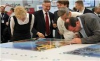 Event attendees view the printer's glass prints